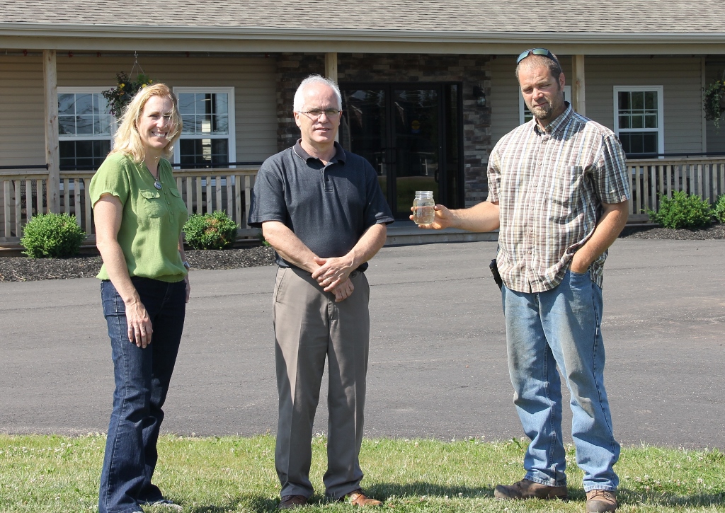 Kelly Galloway with Owner, Alan MacPhee, and septic installer,  Philip Clark (holding bottle of clear effluent)