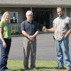 Kelly Galloway with Owner, Alan MacPhee, and septic installer,  Philip Clark (holding bottle of clear effluent)